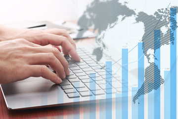 Global business analytics. Businessman analyzing data.Growth graph, world map and laptop.