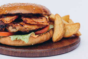 Big single burger with french fries isolated on white background