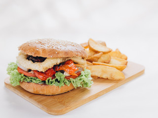 Big tasty burger on background on the wooden table