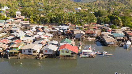 Aerial view Coron city with slums and poor district. Palawan.Wooden houses near the water.Poor neighborhoods and slums in the city of Coron aerial view