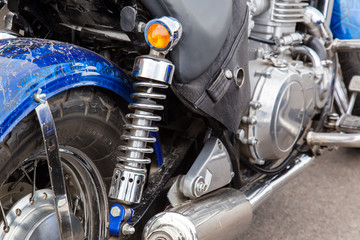 Obraz premium Parts of a racing motorcycle. Wheel, shock absorber and exhaust pipe close-up.