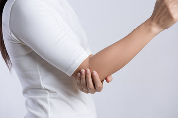 Closeup female's elbow. Arm pain and injury. Health care and medical concept.