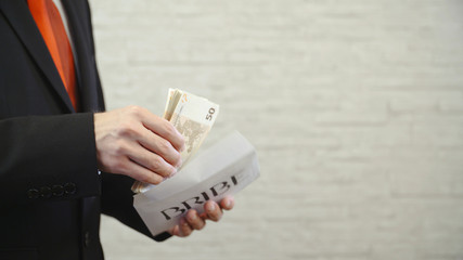 Filling the bribe envelope with money