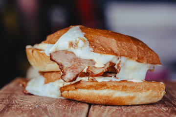 grilled ham and cheese sandwich on wooden background