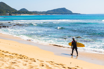 ビーチを歩くサーファー 奄美大島手広海岸 鹿児島県大島郡龍郷町赤尾木