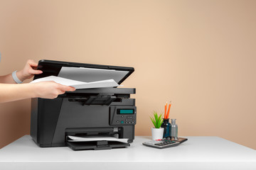 Woman using the printer to scanning and printing document