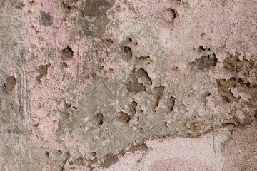 Concrete old wall plaster and paint peeled off due to mosture and aged, texture or background