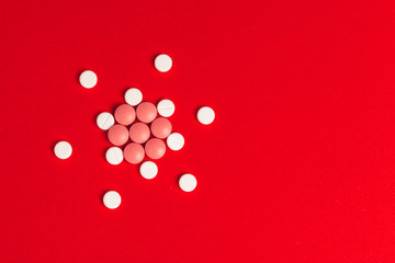 Top view of pharmaceutical medicine pills on red background