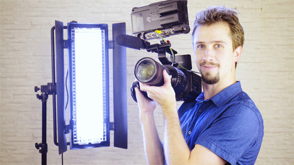 Professional cinematographer with camera and lights