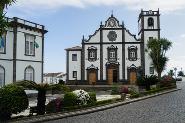 Fototapeta na wymiar Church tower with bells and clock on Sao Miguel Island in Azores, Portugal.