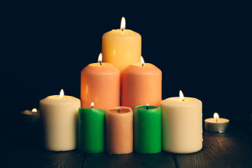 candles burning in darkness over black background. commemoration concept.