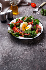 Healthy salad with prosciutto, tomato and egg