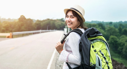 young asian woman traveler with backpack relaxing vacation on mountain
