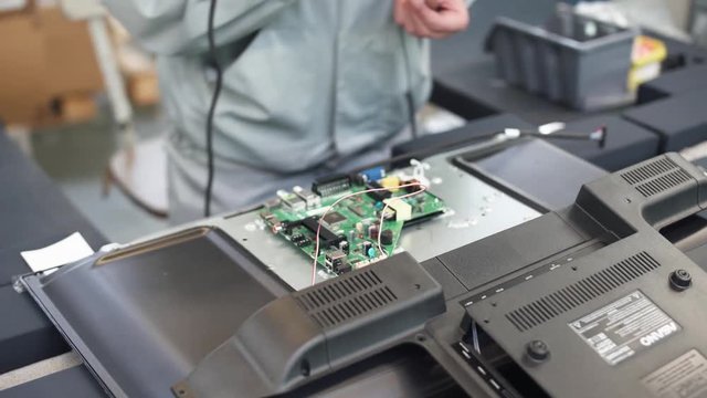 Modern production of TVs, view of the assembly line, the process of assembling TV chips on the conveyor.