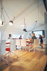 Manager giving a monitor presentation to staff in an office