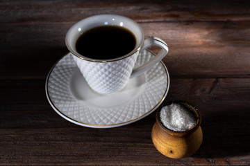 Cup of coffee on a dark wooden background