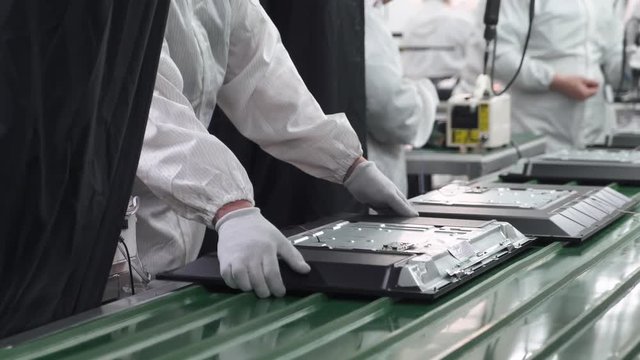 Modern production of TVs, view of the assembly line, the process of assembling TV on the conveyor.