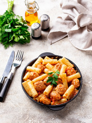 Pasta with meatballs in tomato sauce.