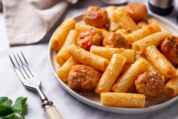 Pasta with meatballs in tomato sauce.