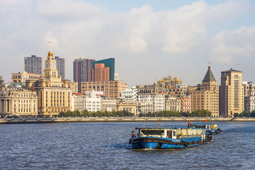 A household waste container ship is traveling on the Huangpu River on the Bund, a historic scenic spot in Shanghai