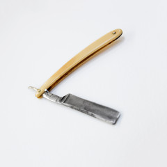 grooming and barber concept - straight shaving razor on white background