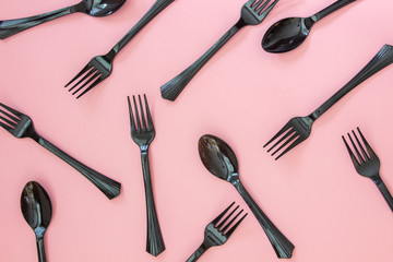 Fototapeta premium Forks and spoons on a pink background. Minimal concept.