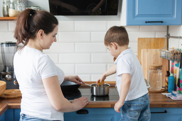 Mom and son cook together.