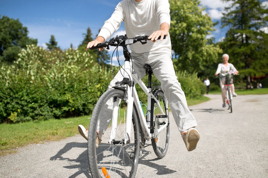 active old age, people and lifestyle concept - happy senior man riding fixie bicycle at summer park