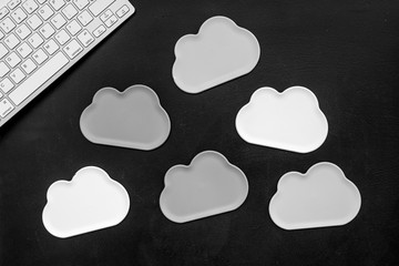 Cloud figures and keyboard for cloud storage on black background top view