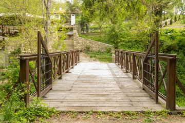 Old wooden bridge in deep forest leading to the countryside.