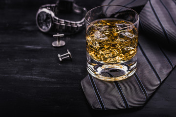Male concept for father's day. Tie, watches, cufflinks and a glass of whiskey with ice