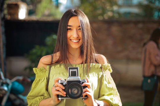 Pretty young woman with a camera.