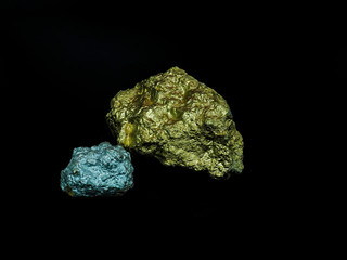 big gold and little silver nugget on black background , precious stone