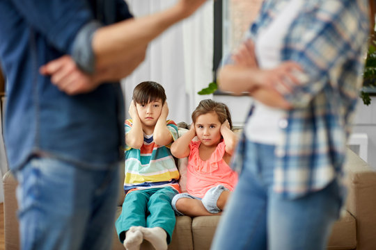 Family Problem, Conflict And People Concept - Sad Children Watching Their Parents Quarreling At Home