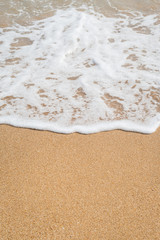 Wave of the sea on the sandy beach