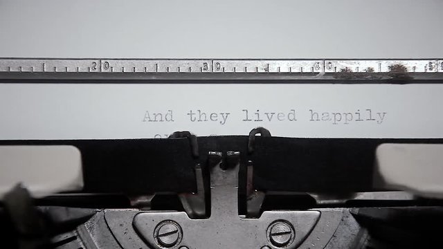 Typing the words And they lived happily ever after, on an old vintage typewriter, under an ominous lighting.