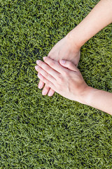 girl hand on soccer field grass