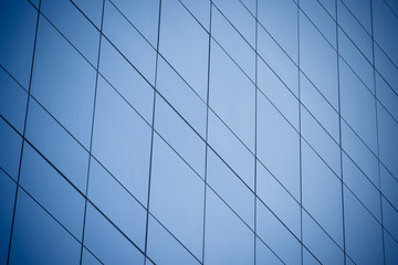 Fototapeta na wymiar Modern office building with blue glass windows