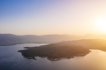 Sunset with golden fog haze in Greek islands next to Poros. Aerial drone photo