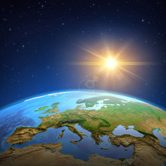 Obraz na płótnie Canvas Sun shining over the Earth from space