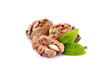 Walnuts in closeup with leaves on white background
