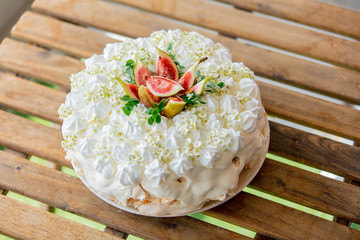 Cream meringue crisp crust cake and with fig on a table