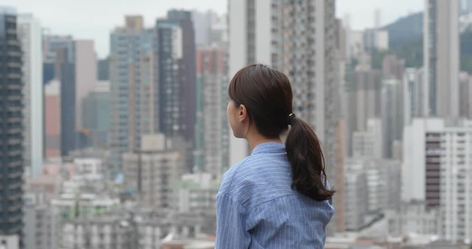 Woman look at the city with crowded of the building