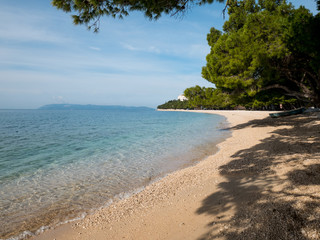 Empty beach and calm blue sea in Tucepi