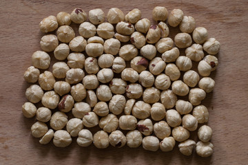 Roasted hazelnuts on a wooden surface. Peeled hazelnut ready to eat