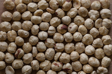 Roasted hazelnuts on a wooden surface. Peeled hazelnut ready to eat