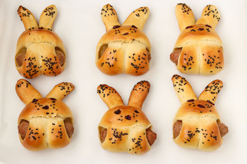 Cooking homemade buns in the shape of rabbits, step by step process, ready-made buns after baking, a culinary idea for children
