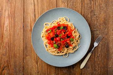 Italian spaghetti alla Pultanesca with tomatoes and olives. Served without meat and cheese.
