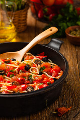 Italian spaghetti alla Pultanesca with tomatoes and olives. Served without meat and cheese.