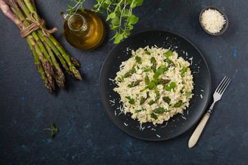 Classic Italian risotto with asparagus. Top view. Darkblue background.